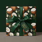 Dark green tropical wrapping paper with coconuts, palm leaves, white flowers, and satin ribbon bow. Exotic gift wrap.