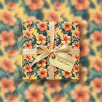 Square gift wrapped in yellow floral wrapping paper with a gold ribbon and "With Love" tag.