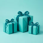 Three tiffany blue gift boxes wrapped with velvet ribbon for a chic birthday, wedding, or baby shower.