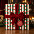 Red and green striped Christmas wrapping paper with a velvet bow by Wrapped Studios.