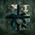 Luxury forest wrapping paper with green velvet ribbon and Adventure Awaits gift tag by Wrapped Studios.