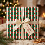 Red and green striped Christmas wrapping paper with red polka dots and cream bow by Wrapped Studios.