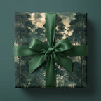 Luxury forest wrapping paper with a dark green satin ribbon on a gift box by Wrapped Studios.