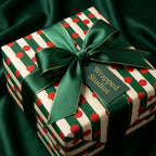 Red polka dot and green striped Christmas wrapping paper with a luxury satin bow by Wrapped Studios.