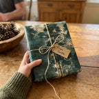 Rustic forest Christmas wrapping paper by Wrapped Studios, tied with twine and a From Santa tag.