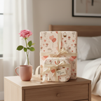Romantic "Mine & Yours" Valentine's Day wrapping paper with hearts, balloons, and subtle pink ribbons on two gift boxes in a bedroom setting.