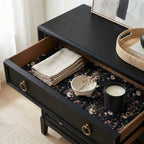 Dark floral wrapping paper used as a drawer liner in a black dresser. Vintage gift wrap by Wrapped Studios.