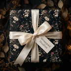 Luxury dark floral wrapping paper with a cream satin bow and vintage botanical design by Wrapped Studios.
