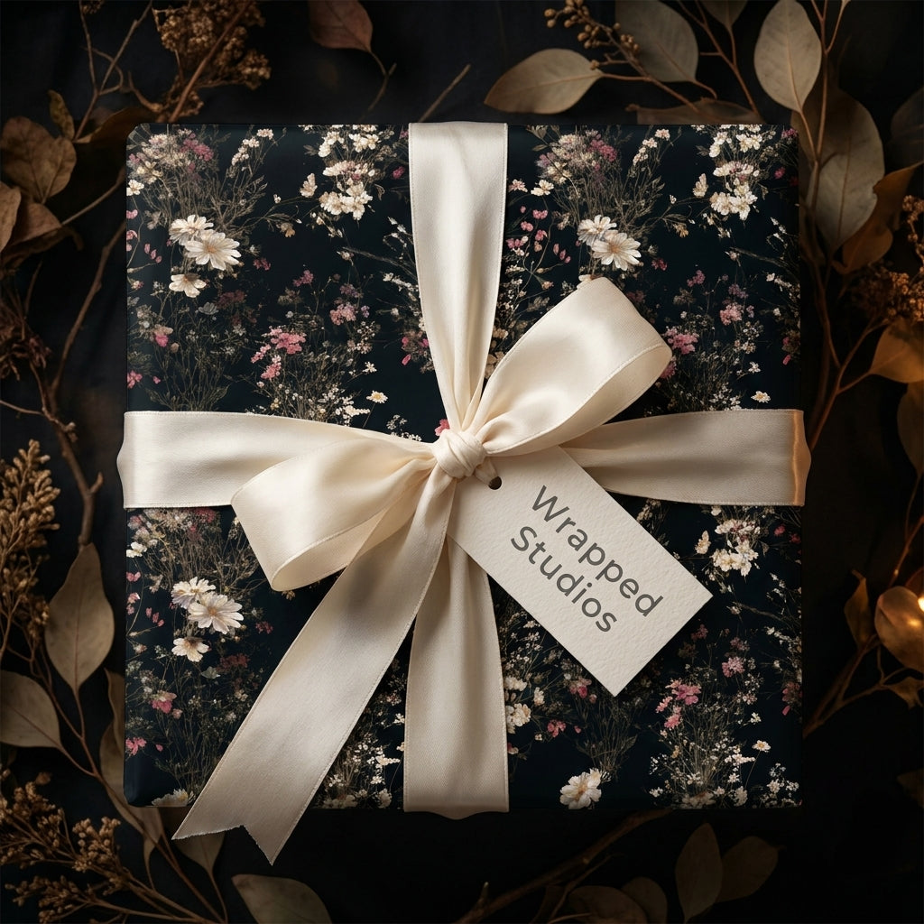 Luxury dark floral wrapping paper with a cream satin bow and vintage botanical design by Wrapped Studios.