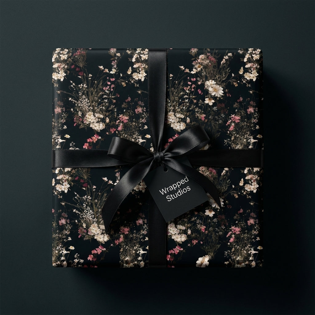 Luxury dark floral wrapping paper on a gift box with a black satin ribbon, by Wrapped Studios.