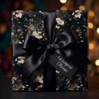 Dark gothic floral wrapping paper with a black satin bow and gift tag by Wrapped Studios.