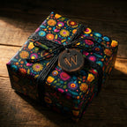 Square gift in Wrapped Studios' dark floral wrapping paper with black string and wooden tag.