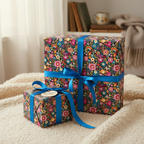 Floral wrapping paper on gifts with bright blue ribbon against a neutral backdrop.