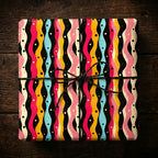 Colorful modern gift wrap with wavy stripes on a square box, tied with black twine.