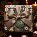Luxury Christmas gift wrap with vintage ornament pattern and elegant satin bow by Wrapped Studios.