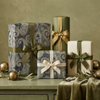 Elegant paisley wrapping paper and sage green holiday gift wrap with luxury ribbons by Wrapped Studios.