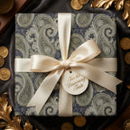 Luxury paisley wrapping paper in navy and olive green with a cream satin bow by Wrapped Studios.