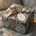Vintage paisley luxury gift wrap in blue and gold with a satin bow on a gift box by Wrapped Studios.