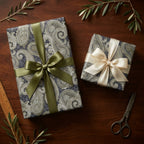 Luxury blue and gold paisley wrapping paper with satin bows on gift boxes, by Wrapped Studios.