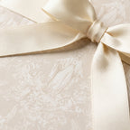 Elegant Catholic Virgin Mary wrapping paper with cream satin bow for baptism or communion by Wrapped Studios.