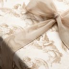 Vintage angel Christmas wrapping paper with a sheer beige bow, luxury holiday gift wrap by Wrapped Studios.