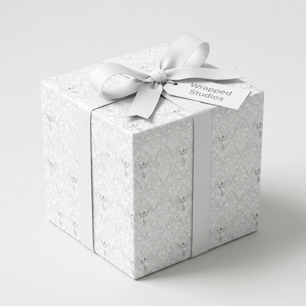 Elegant white angel wrapping paper on a luxury gift box with ribbon by Wrapped Studios.