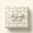 Vintage angel Christmas wrapping paper with cream ribbon, luxury holiday gift wrap by Wrapped Studios.