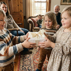 Children exchanging a gift in elegant floral wrapping paper with satin ribbon by Wrapped Studios.