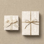 Elegant vintage religious wrapping paper with gold and cream ribbons by Wrapped Studios.