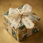 Luxury vintage Christmas wrapping paper with angel pattern, sheer gold ribbon, and tag by Wrapped Studios.