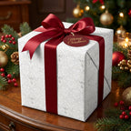 Luxury white angel Christmas wrapping paper with a red satin bow by Wrapped Studios.