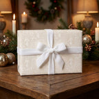 Luxury Christmas gift wrap with vintage cream angel pattern and velvet ribbon by Wrapped Studios.