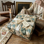 Luxury vintage angel wrapping paper in teal and cream with a satin bow by Wrapped Studios.