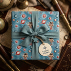 Vintage astronaut space wrapping paper with a teal ribbon and gift tag by Wrapped Studios.