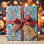 Outer space birthday wrapping paper with cute astronauts, planets, and a red bow by Wrapped Studios.
