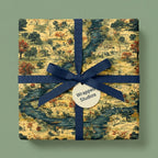 Elegant gift box wrapped in vintage-style scenic toile wrapping paper with a navy blue ribbon.