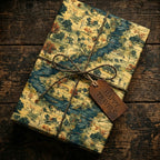 Vintage scenic travel wrapping paper with river and trees, tied with twine and a "Happy Travels" tag.