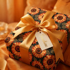 Floral sunflower wrapping paper with a luxury gold satin ribbon on a gift box by Wrapped Studios.