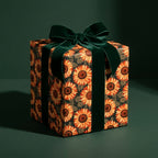 Luxury sunflower wrapping paper with a green velvet bow on a gift box by Wrapped Studios.