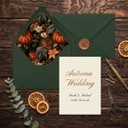 Moody autumn wedding invitation with forest green envelope and botanical pumpkin liner by Wrapped Studios.