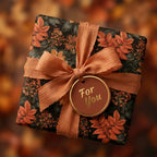 Luxury autumn wrapping paper with orange botanical leaves, terracotta ribbon, and gift tag by Wrapped Studios.