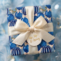 Blue hot air balloon baby shower wrapping paper with ivory satin bow, by Wrapped Studios.