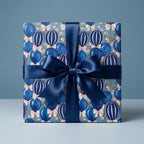 Luxury blue balloon birthday wrapping paper with a satin ribbon bow by Wrapped Studios.