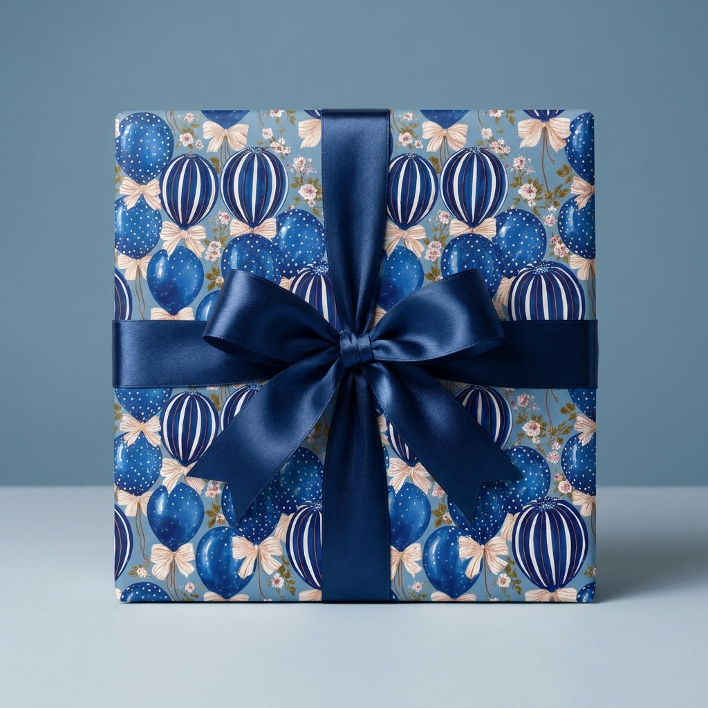 Luxury blue balloon birthday wrapping paper with a satin ribbon bow by Wrapped Studios.