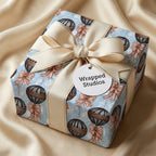 Vintage hot air balloon wrapping paper by Wrapped Studios on a luxury gift box with a cream bow.