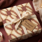 Vintage baseball wrapping paper on a gift box with cream ribbon by Wrapped Studios.