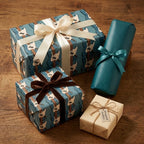 Blue electric guitar wrapping paper with ribbons on a wood table, music gift wrap by Wrapped Studios.