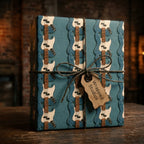 Teal electric guitar wrapping paper with a twine bow by Wrapped Studios, ideal for music lovers.