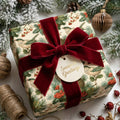 Vintage botanical Christmas wrapping paper with a luxury red velvet bow by Wrapped Studios.