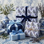 Luxury lavender floral wrapping paper with blue velvet and satin ribbons by Wrapped Studios.